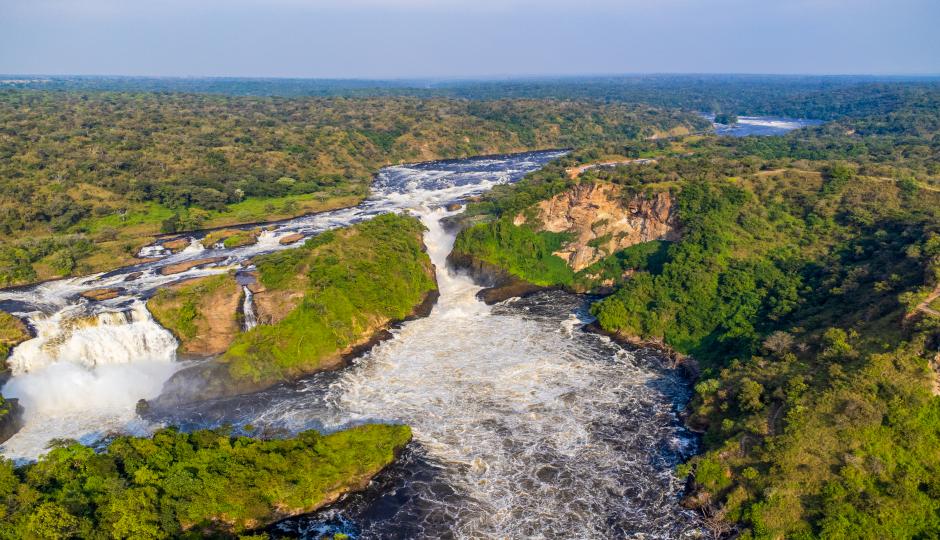 Aerial view of the Nile forcing through the gorge at Murchison Falls, surrounded by dense green bush